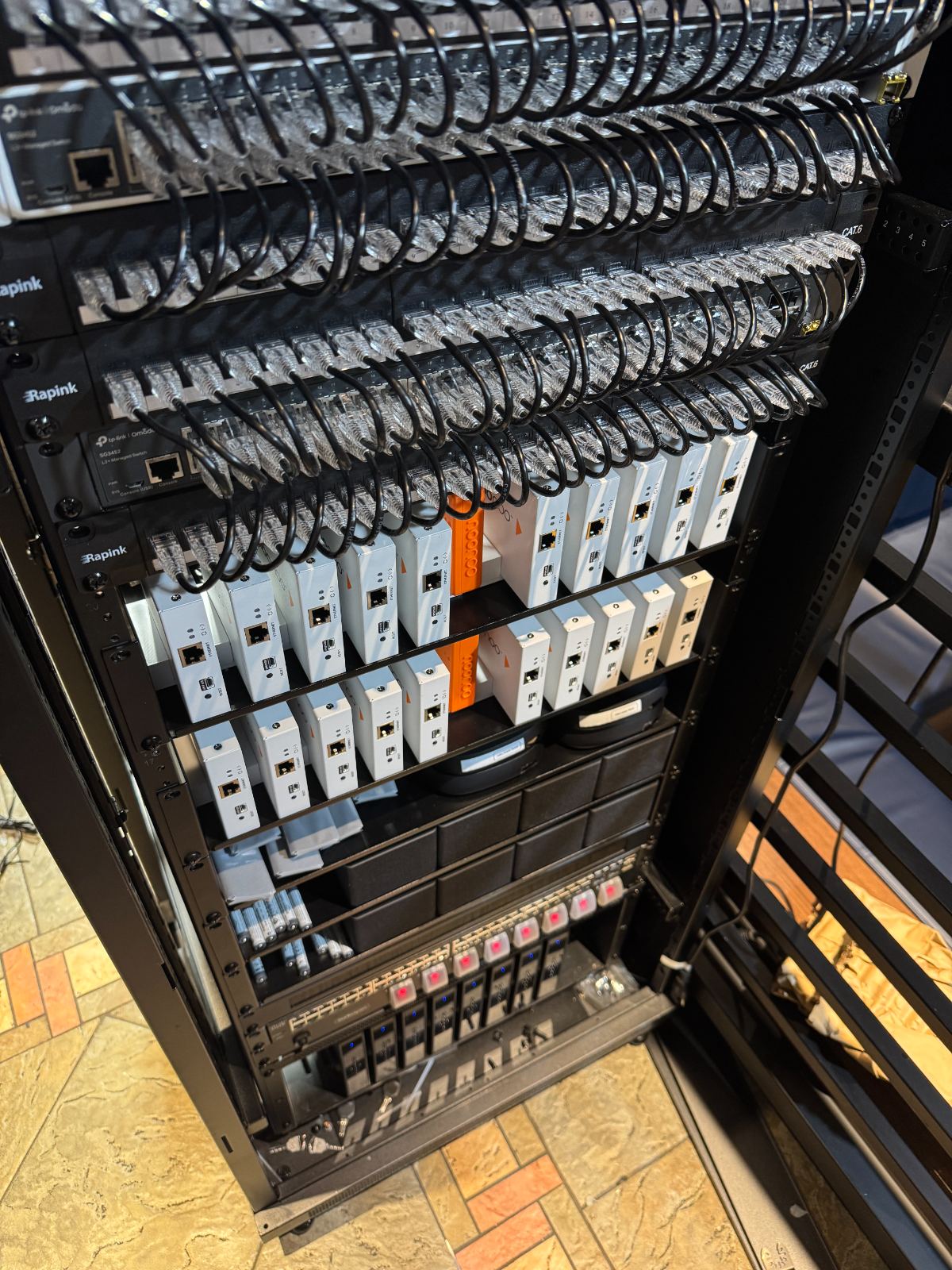 The rack from the side, endpoints stacked with the switching
