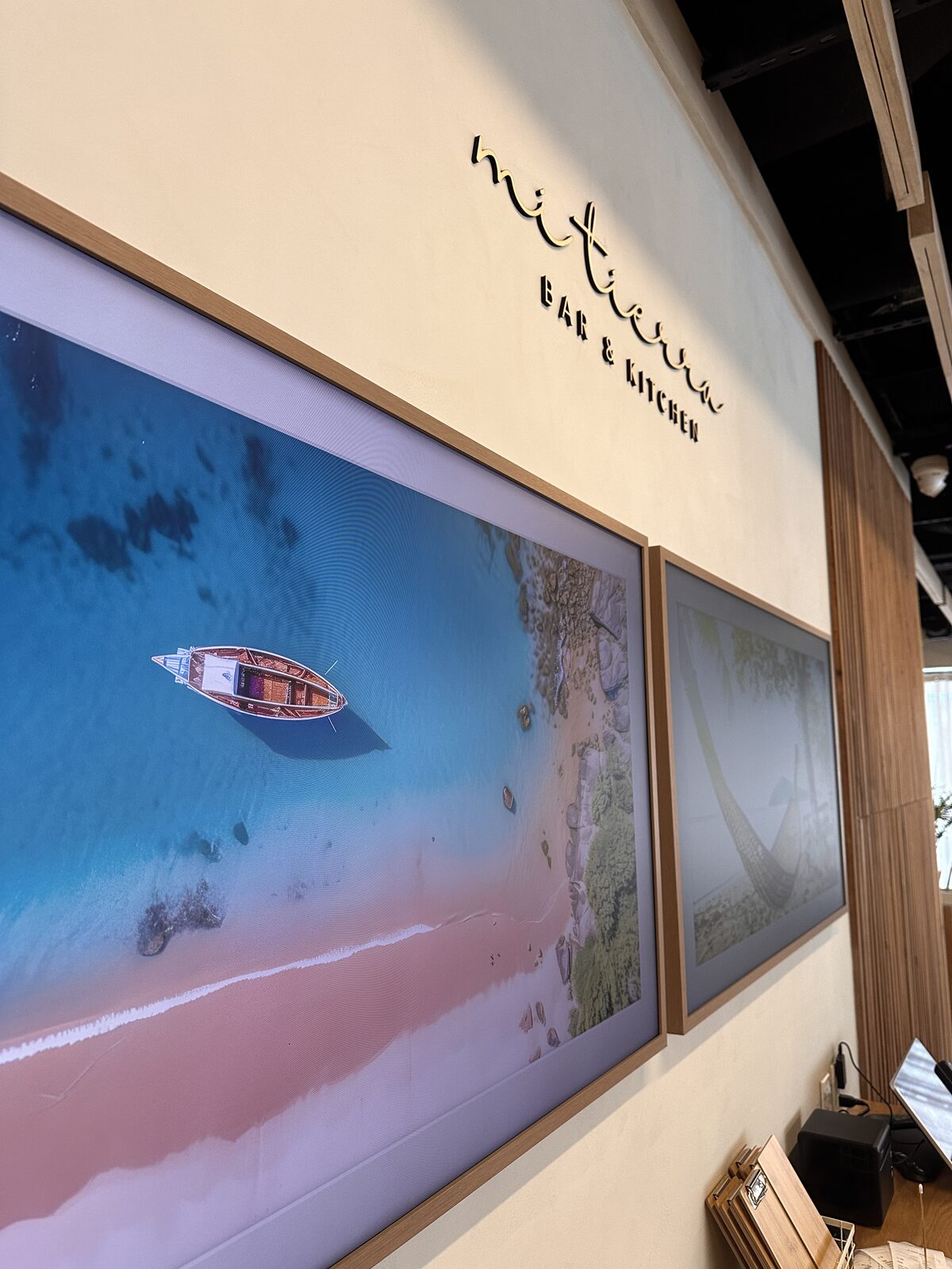 A framed image on the restaurant's art wall beneath its mark