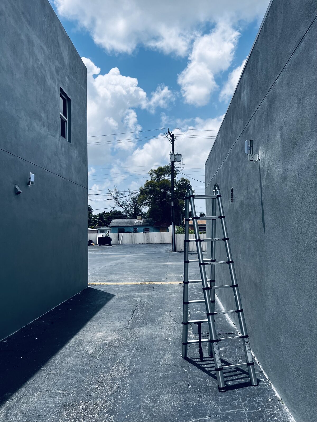 Cameras mounted high on a rendered wall above a parking lot