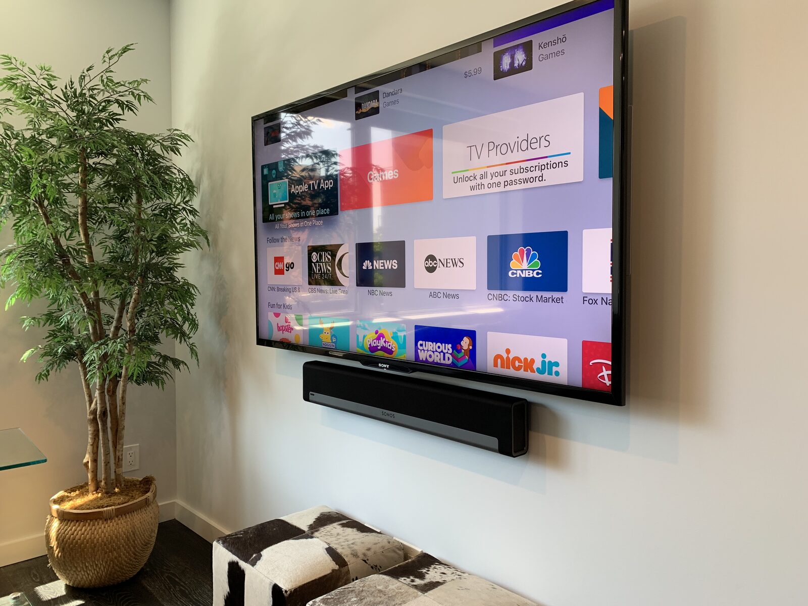 A living room display and soundbar with its streaming home screen up