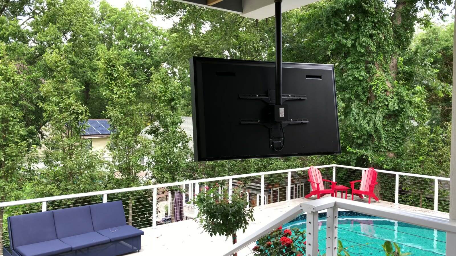 A weatherproof display mounted on a covered deck above the pool