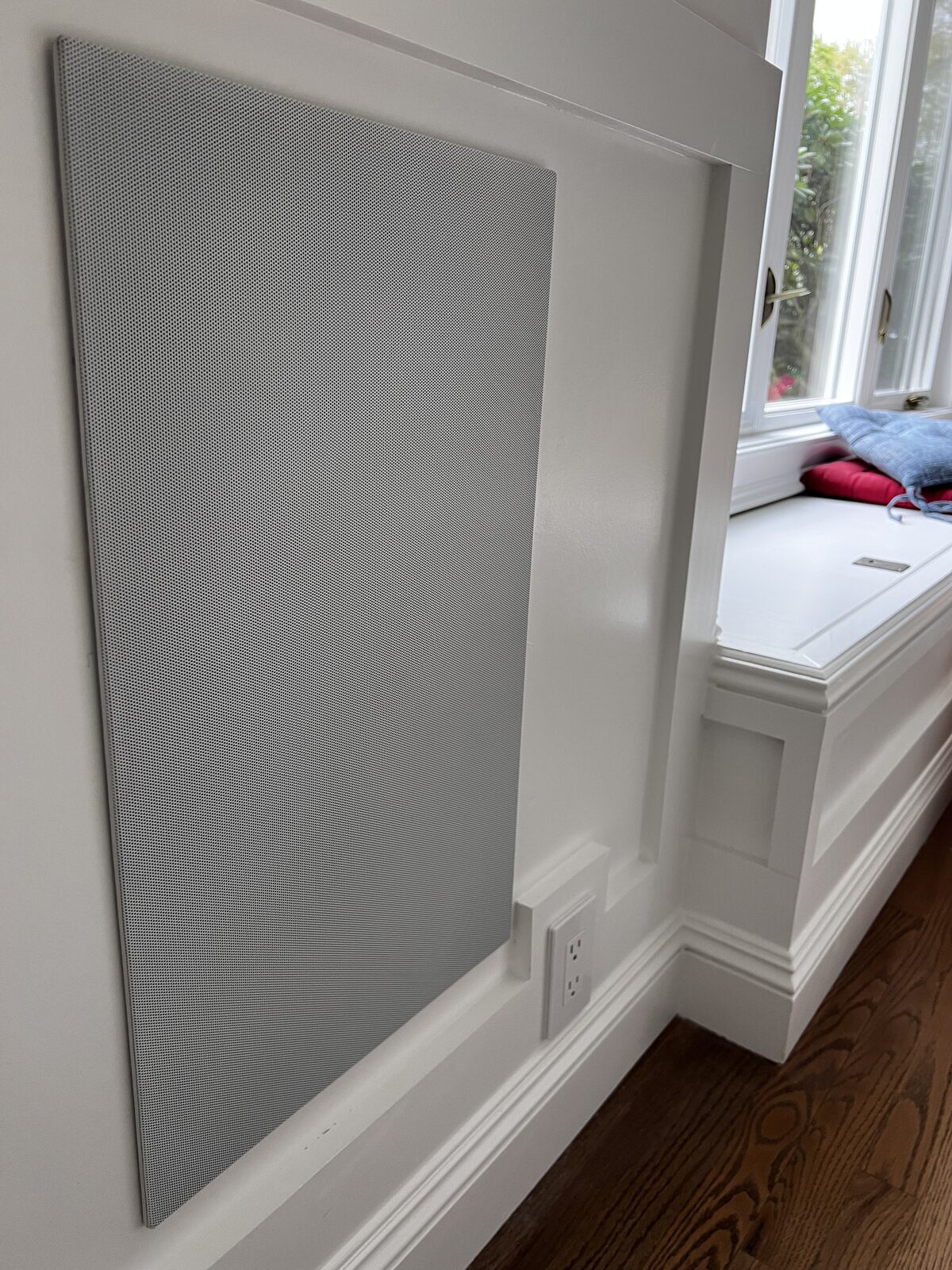 An in-wall speaker panel finished flush with the wall